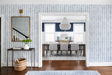 Inspiration for a coastal medium tone wood floor, brown floor and wallpaper hallway remodel in DC Metro with blue walls