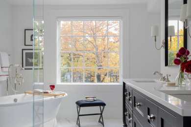 Freestanding bathtub - traditional white tile marble floor, white floor and double-sink freestanding bathtub idea in Boston with black cabinets, an undermount sink, marble countertops, white countertops and a freestanding vanity