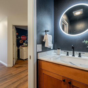 Modern Powder Room with Deep Navy Walls and Backlit LED Mirror