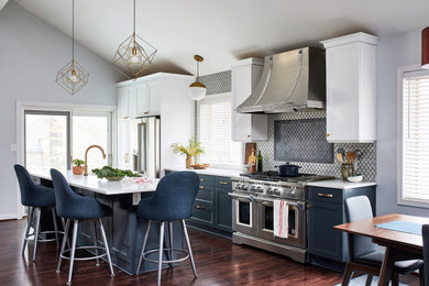 Inspiration for a large transitional dark wood floor eat-in kitchen remodel in DC Metro with blue cabinets, stainless steel appliances, an island and white countertops