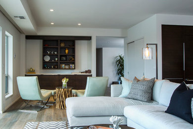 Example of a large trendy open concept dark wood floor family room design in Hawaii with white walls and no fireplace