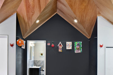 Large trendy enclosed medium tone wood floor game room photo in New York with gray walls