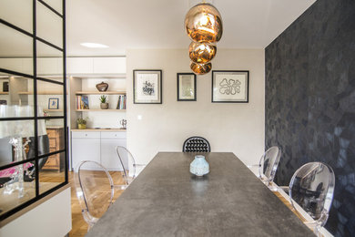 This is an example of a mid-sized eclectic open plan dining in Strasbourg with beige walls, light hardwood floors and brown floor.