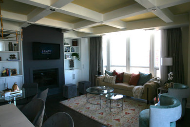 Example of a mid-sized transitional open concept family room design in Toronto with beige walls, a standard fireplace, a plaster fireplace and a media wall