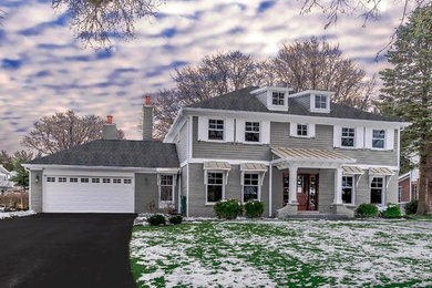 Large elegant gray two-story mixed siding house exterior photo in Chicago with a clipped gable roof and a shingle roof