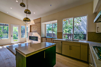Inspiration for a mid-sized contemporary u-shaped light wood floor and brown floor open concept kitchen remodel in San Diego with an undermount sink, flat-panel cabinets, beige cabinets, brown backsplash, stainless steel appliances and an island