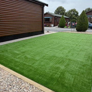 Artificial Lawn Held on a Timber Edge Above Shingle
