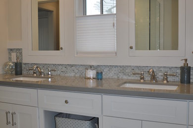Alcove shower - mid-sized contemporary master blue tile, gray tile and mosaic tile medium tone wood floor alcove shower idea in Los Angeles with recessed-panel cabinets, white cabinets, white walls, an undermount sink and solid surface countertops
