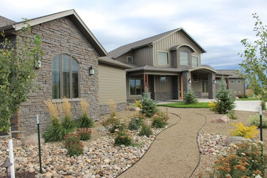 Large rustic beige two-story mixed siding exterior home idea in Other with a hip roof