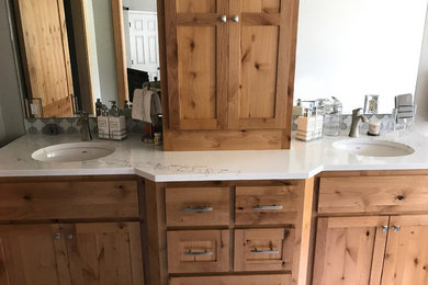 Example of a large transitional master white tile and marble tile travertine floor and beige floor bathroom design in Other with shaker cabinets, dark wood cabinets, beige walls, a drop-in sink, marble countertops and a hinged shower door