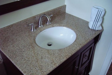 Example of a classic bathroom design in Salt Lake City with a drop-in sink, louvered cabinets, dark wood cabinets, quartz countertops and white walls