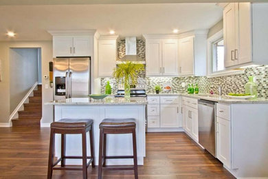 Trendy l-shaped open concept kitchen photo in Toronto with an undermount sink, shaker cabinets, granite countertops, gray backsplash, stainless steel appliances and an island