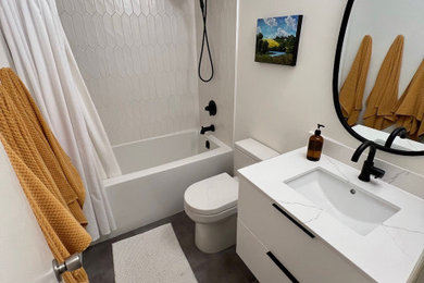 Inspiration for a mid-sized modern master white tile laminate floor, gray floor and single-sink alcove bathtub remodel in Other with flat-panel cabinets, white cabinets, a one-piece toilet, an undermount sink, quartz countertops, white countertops and a floating vanity