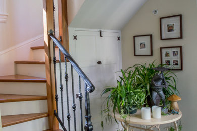 Imagen de escalera en U tradicional renovada con escalones de madera, contrahuellas de madera pintada y barandilla de metal