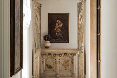 Hallway - mediterranean beige floor hallway idea in Houston with white walls