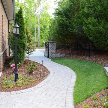 Paver sidewalk leading from the driveway to the backyard.