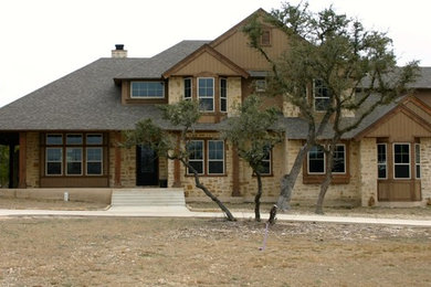 Inspiration for a large country beige two-story mixed siding exterior home remodel in Austin with a shingle roof