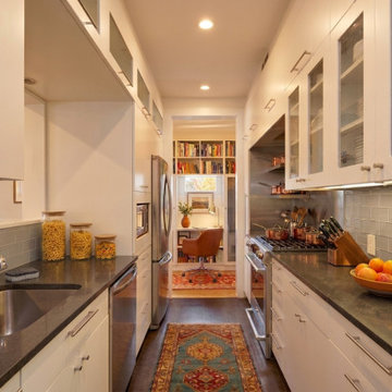 Kitchen featuring glass backsplash