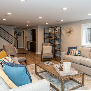 Photo of a large retro walk-out basement in Chicago with grey walls, vinyl flooring, a corner fireplace, a brick fireplace surround and brown floors.