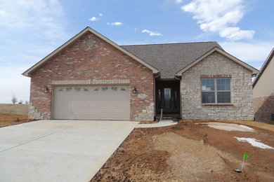 Inspiration for a modern beige one-story stone exterior home remodel in St Louis