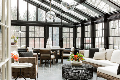 Large transitional sunroom in Boston with a glass ceiling and grey floor.