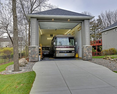 Inspiration for a large timeless detached three-car garage remodel in 