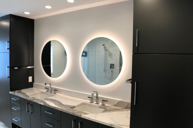 Inspiration for a contemporary master gray tile and porcelain tile porcelain tile, gray floor and double-sink bathroom remodel in Cedar Rapids with flat-panel cabinets, gray cabinets, a one-piece toilet, gray walls, an undermount sink, quartz countertops and a floating vanity