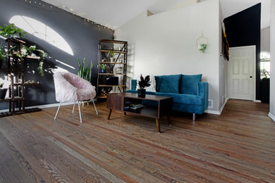 Mid-sized transitional medium tone wood floor and brown floor living room photo in Denver with gray walls