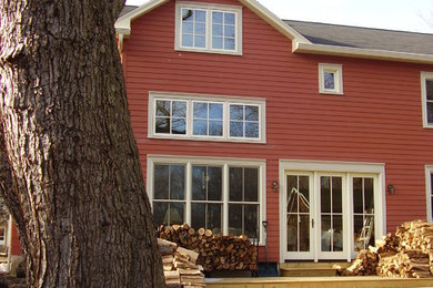 This is an example of a small eclectic two-storey red exterior in Newark with concrete fiberboard siding.