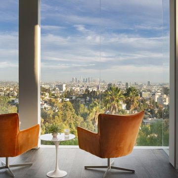 Los Tilos Hollywood Hills luxury hillside home modern primary bedroom seating ar