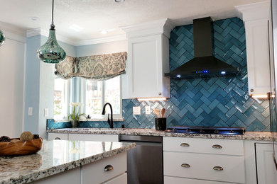 This is an example of a mid-sized transitional l-shaped eat-in kitchen in Sacramento with a single-bowl sink, shaker cabinets, white cabinets, granite benchtops, blue splashback, ceramic splashback, black appliances, medium hardwood floors, with island, brown floor and multi-coloured benchtop.