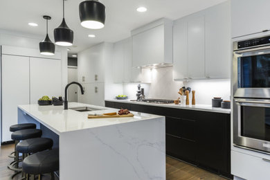 Inspiration for a large modern light wood floor and beige floor eat-in kitchen remodel in Los Angeles with an undermount sink, flat-panel cabinets, white cabinets, quartz countertops, white backsplash, stone slab backsplash, stainless steel appliances, an island and white countertops