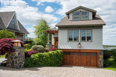 Mid-sized rustic blue two-story mixed siding house exterior idea in Portland Maine with a hip roof and a shingle roof