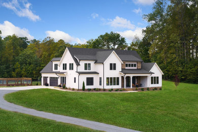 Example of a farmhouse exterior home design in Raleigh