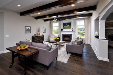 Photo of a large country open concept family room in Chicago with grey walls, dark hardwood floors, a standard fireplace, a stone fireplace surround and a wall-mounted tv.