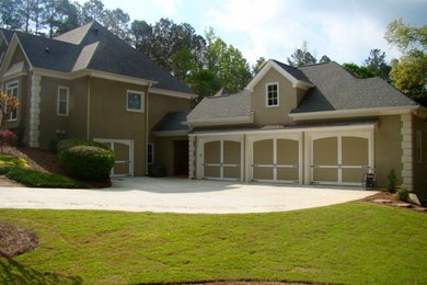 Photo of an expansive traditional detached three-car garage in Atlanta.