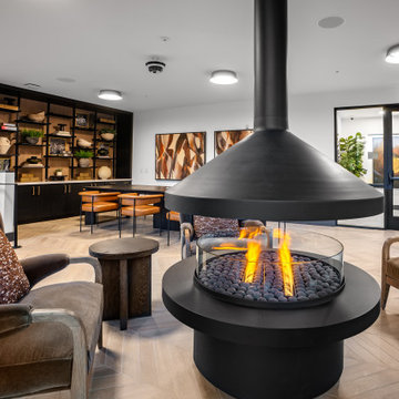 Cozy vibes, elevated design.   Gather around the statement fireplace in our stun