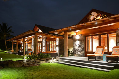 Inspiration for a large tropical two-storey exterior in Hawaii with wood siding.