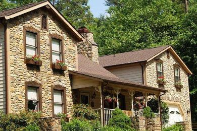 Large brown two-story exterior home idea in Other