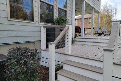 Inspiration for a large contemporary backyard cable railing deck remodel in Charlotte with no cover