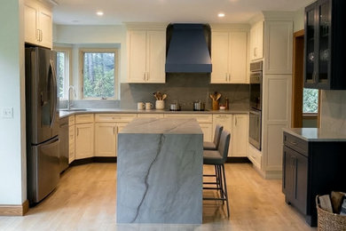 Kitchen - u-shaped kitchen idea in Providence with an island