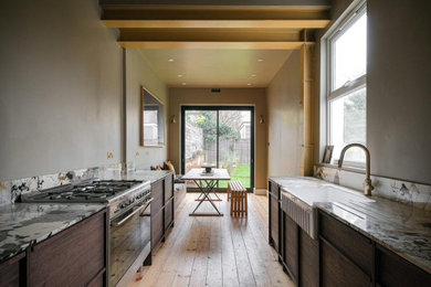 Medium sized modern kitchen in London with marble worktops.