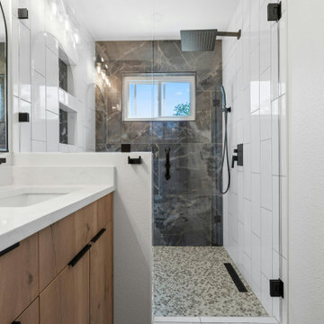 Primary Bath with Rustic Oak Flat Cabinets and Black Tile