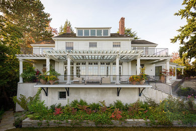 Inspiration for a timeless white two-story exterior home remodel in Seattle with a hip roof
