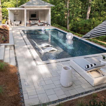 Traditional Pool Patio with Grey Pavers and A Cobblestone Inlay