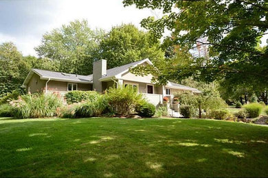 Mid-sized 1960s beige two-story mixed siding exterior home photo in Other with a shingle roof