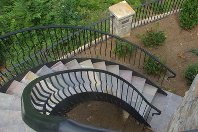Photo of a mid-sized transitional partial sun backyard stone landscaping in Atlanta.