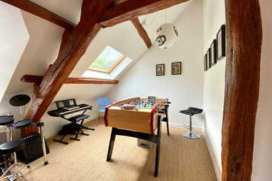 Example of an eclectic carpeted, brown floor, exposed beam and vaulted ceiling game room design in Paris with white walls