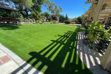 Design ideas for a large drought-tolerant and partial sun backyard concrete paver landscaping in Los Angeles.