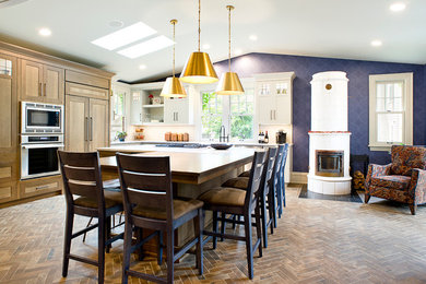 Arts and crafts l-shaped brown floor kitchen photo in Other with shaker cabinets, white cabinets, stainless steel appliances, an island and white countertops